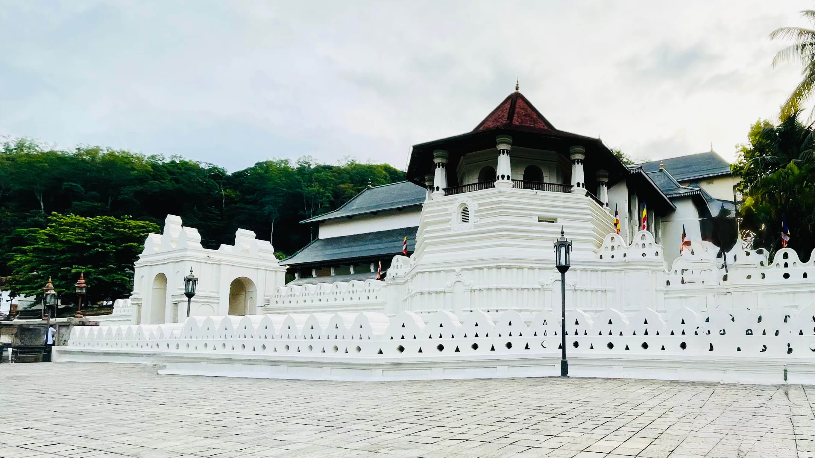 Temple of the Tooth exterior, Kandy Lake reflection